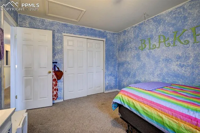 a room that has a bed and a table in it