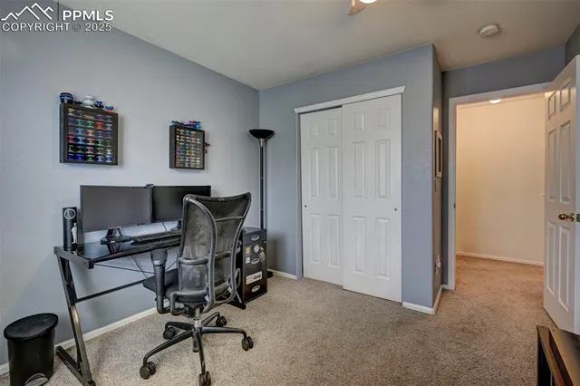a view of a workspace with furniture and a window