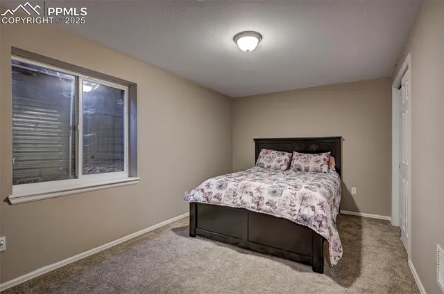 a bedroom with a bed and a television