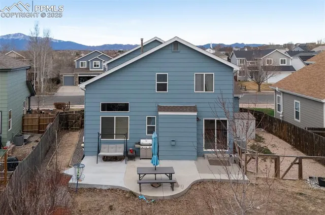 an aerial view of a house with a yard