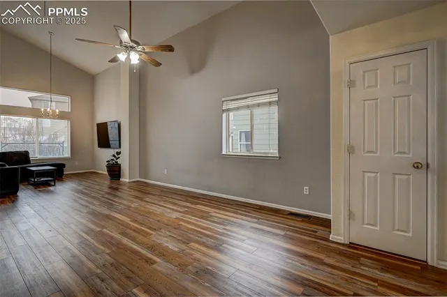 a view of empty room with wooden floor