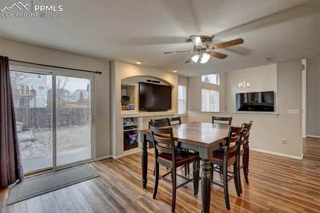 a view of a dining room with furniture window and wooden floor
