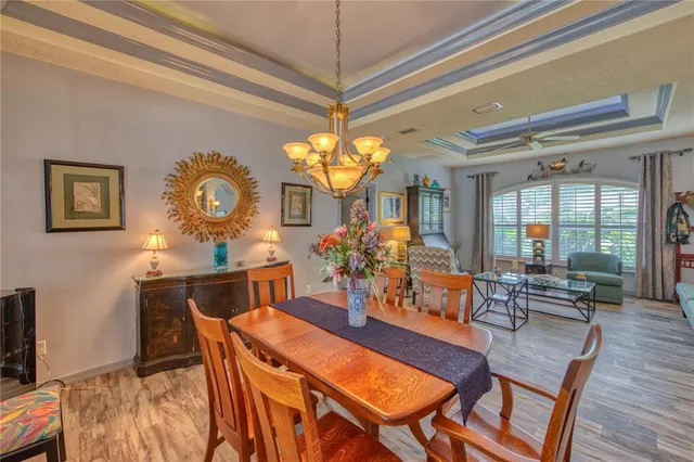 a view of a dining room with furniture and chandelier