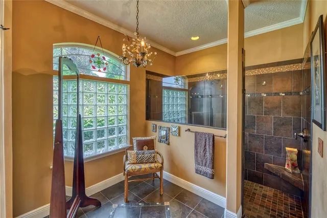 a very nice looking room with a large window and chandelier