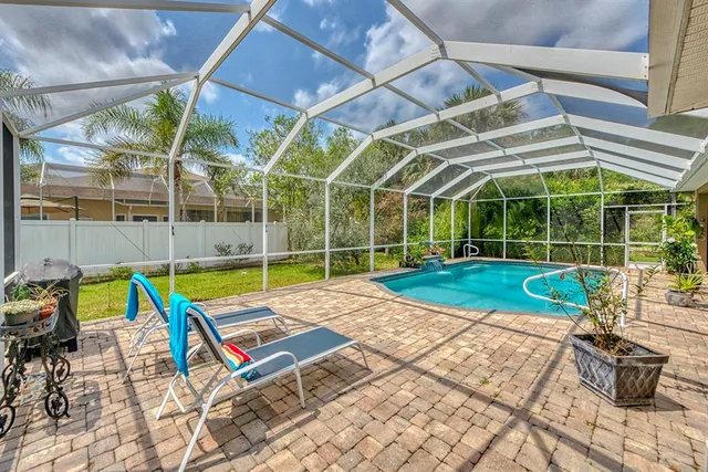 a view of a backyard with swimming pool