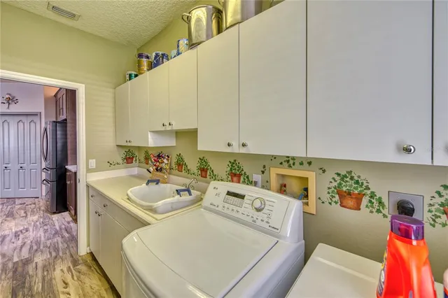 a kitchen with granite countertop kitchen island stainless steel appliances a dining table and chairs
