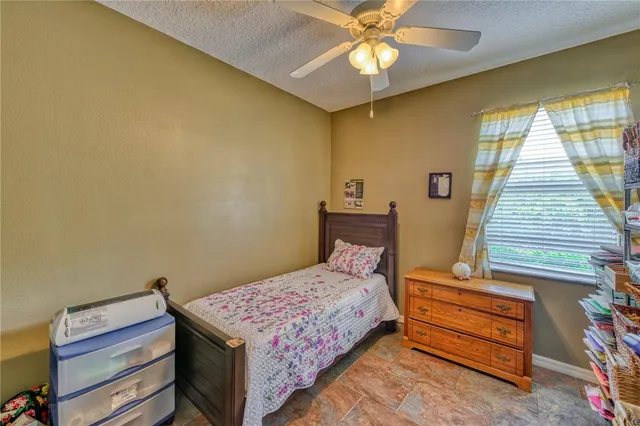 a bedroom with a bed and a dresser in it