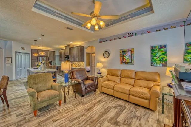 a living room with furniture and a chandelier
