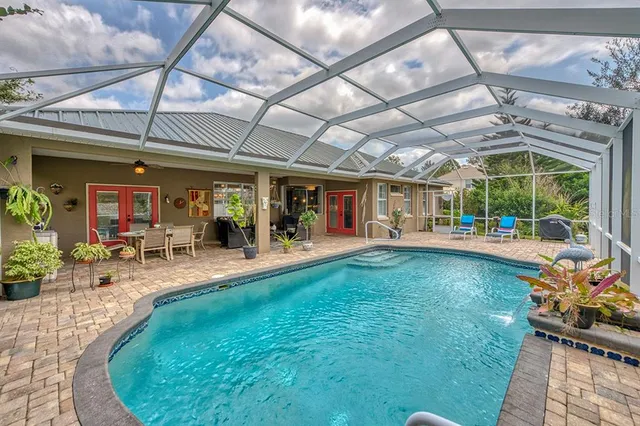 a view of a backyard with a patio and a garden