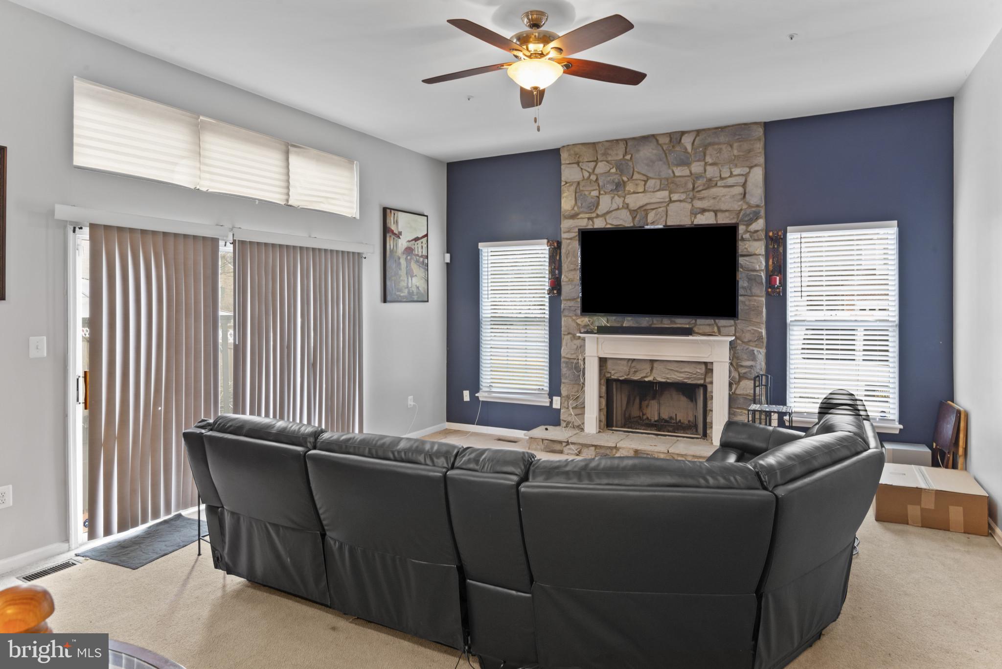 500 Treehouse Court Fort Washington, MD 20744 - Photo 11 of 25 a living room with furniture a flat screen tv and a fireplace