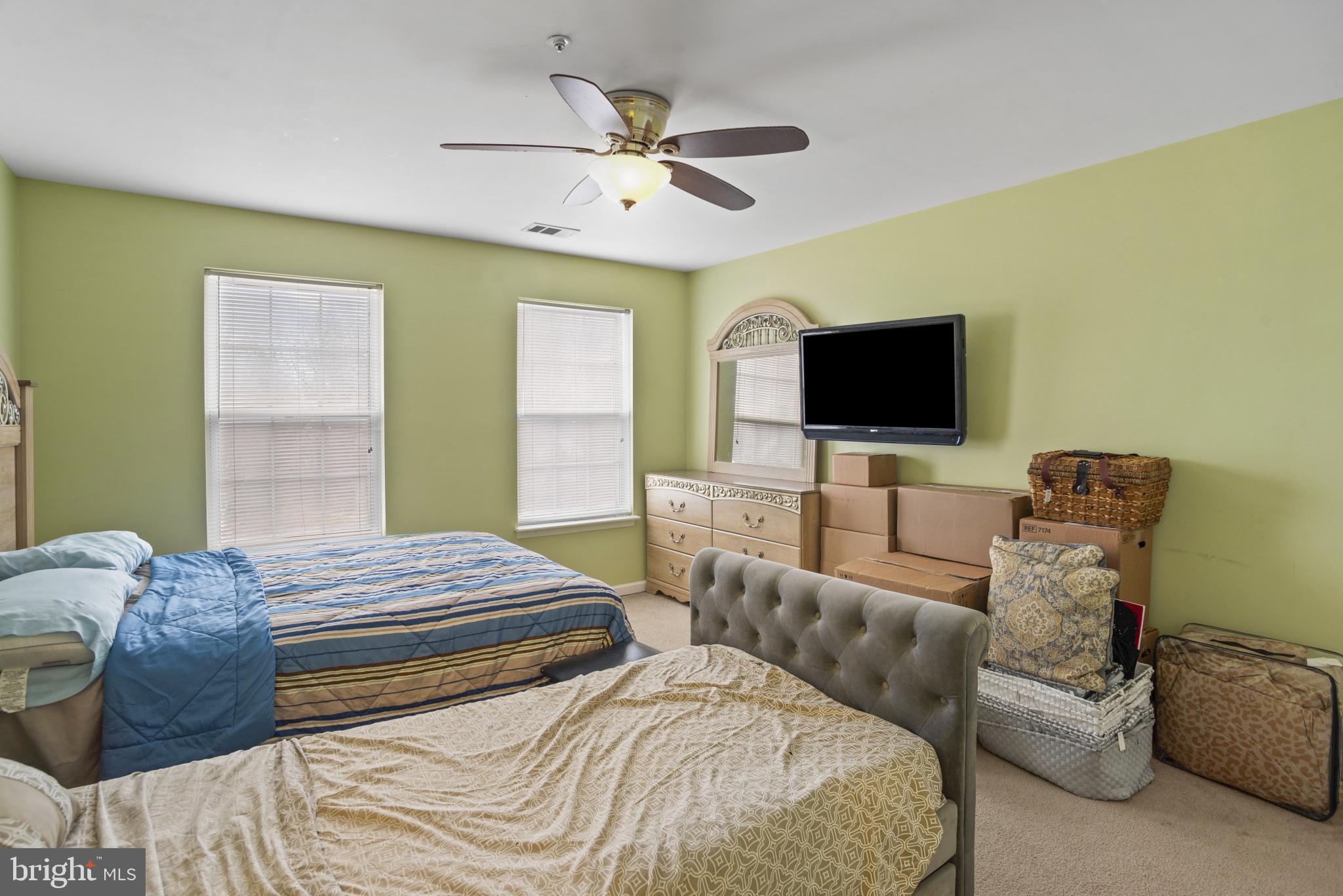 500 Treehouse Court Fort Washington, MD 20744 - Photo 17 of 25 a bedroom with a bed and a flat screen tv