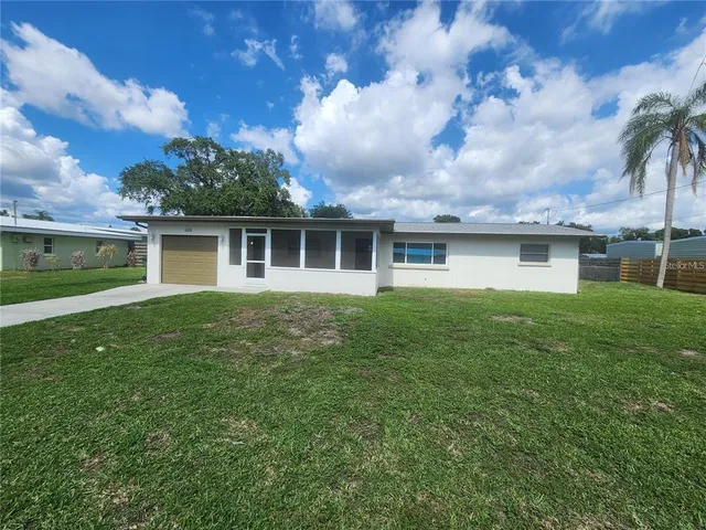 a front view of house with yard and green space