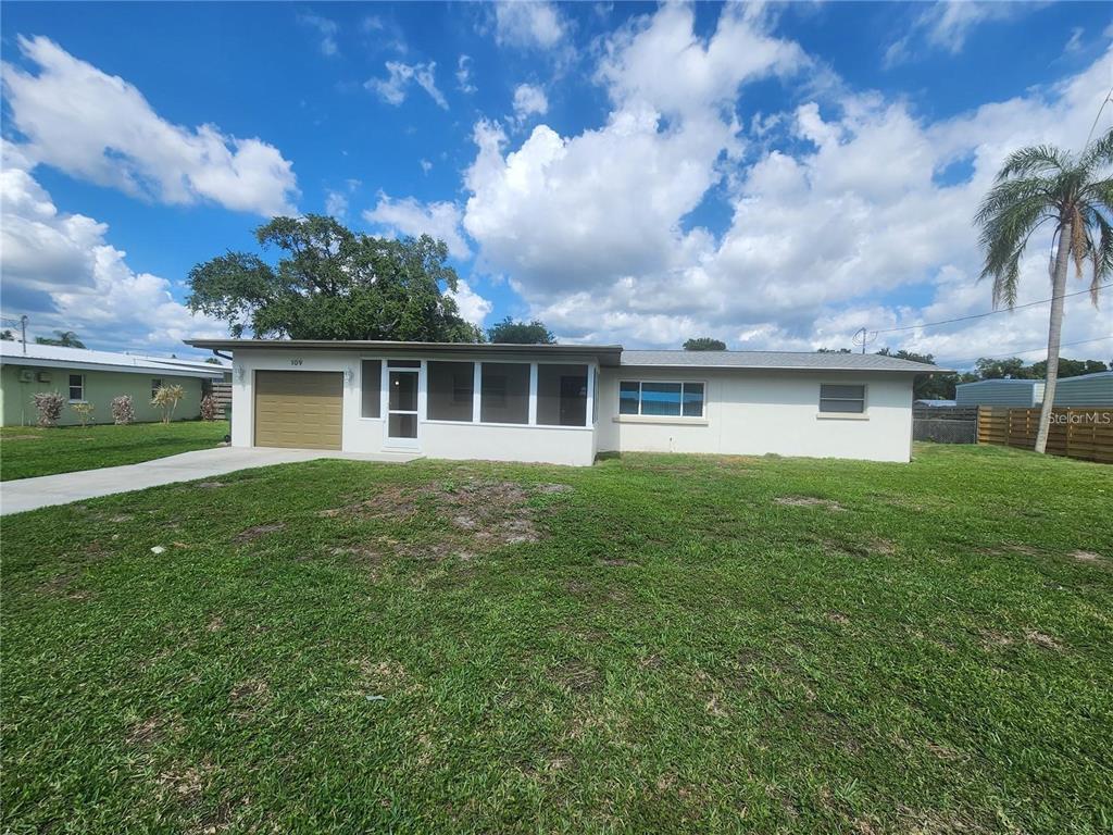 a front view of house with yard and green space