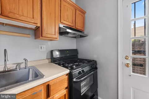 a kitchen with stainless steel appliances granite countertop a sink and a stove
