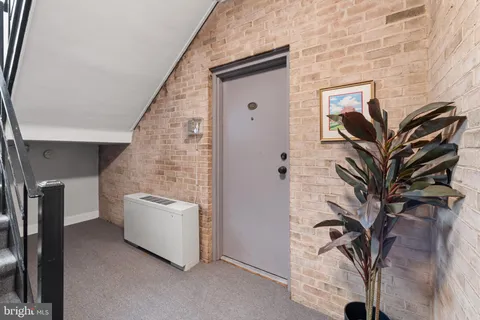 a view of living room with furniture and a potted plant