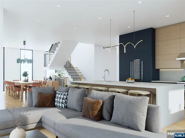 a living room with furniture kitchen view and a large window