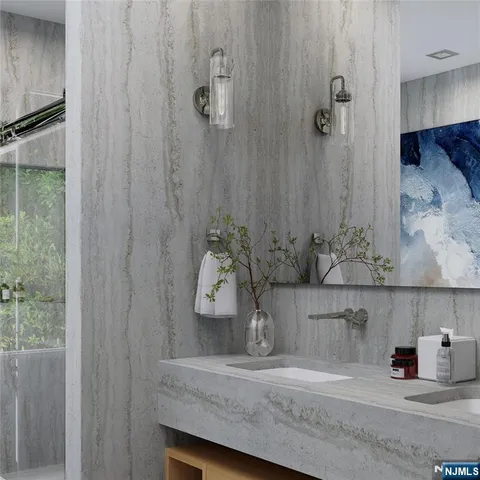 a bathroom with a granite countertop sink a mirror and shower