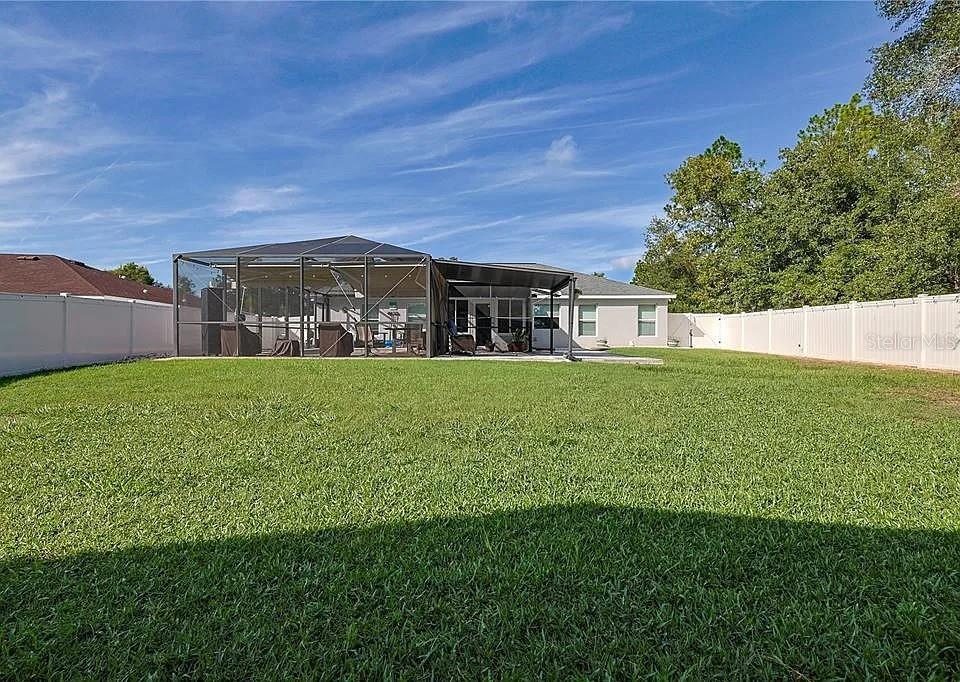 6367 Southwest 117th St Road Ocala, FL 34476 - Photo 22 of 22 a view of a house with a big yard