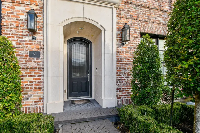a view of a bedroom with wooden floor and a ceiling fan