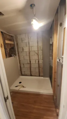 a bathroom with a bathtub and shower