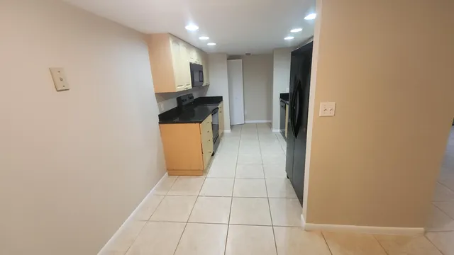 a kitchen with stainless steel appliances granite countertop a sink and a microwave