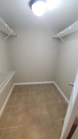 a view of a kitchen with stainless steel appliances a sink and a refrigerator