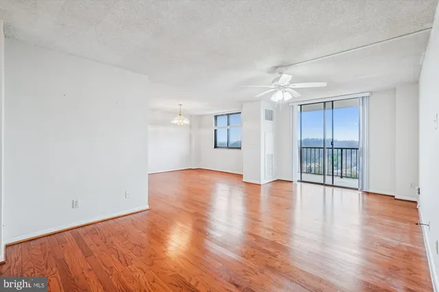 a view of an empty room with wooden floor