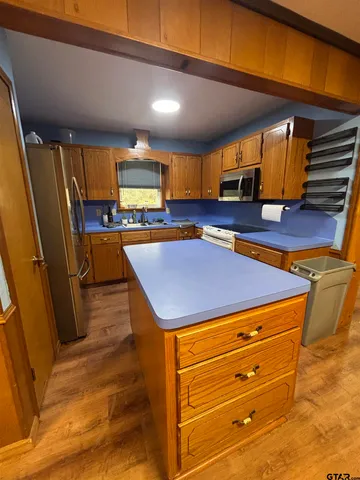a room with pool table a window and potted plant