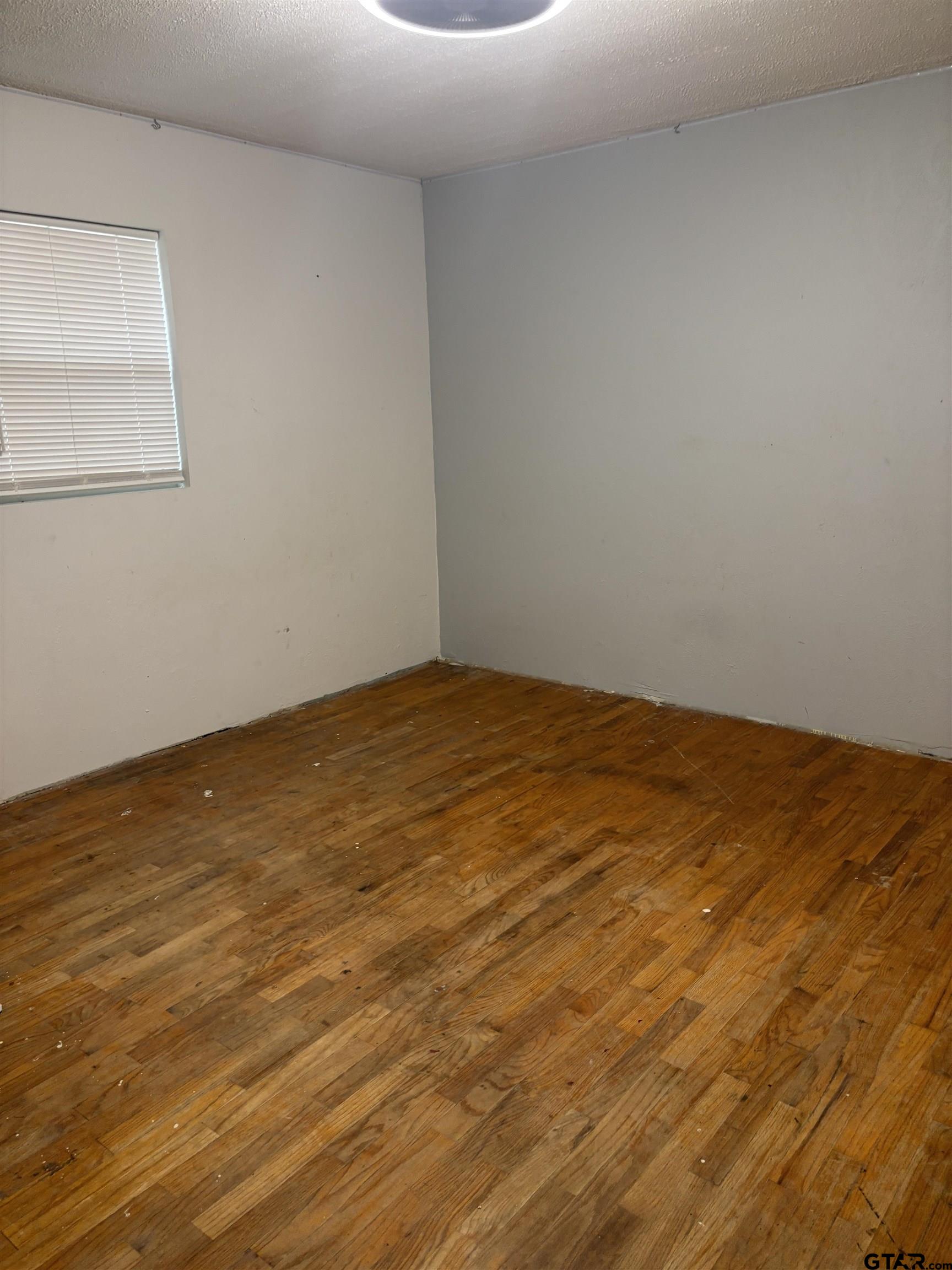 8123 Cherokee Trace Gilmer, TX 75644 - Photo 17 of 26 a view of empty room with wooden floor