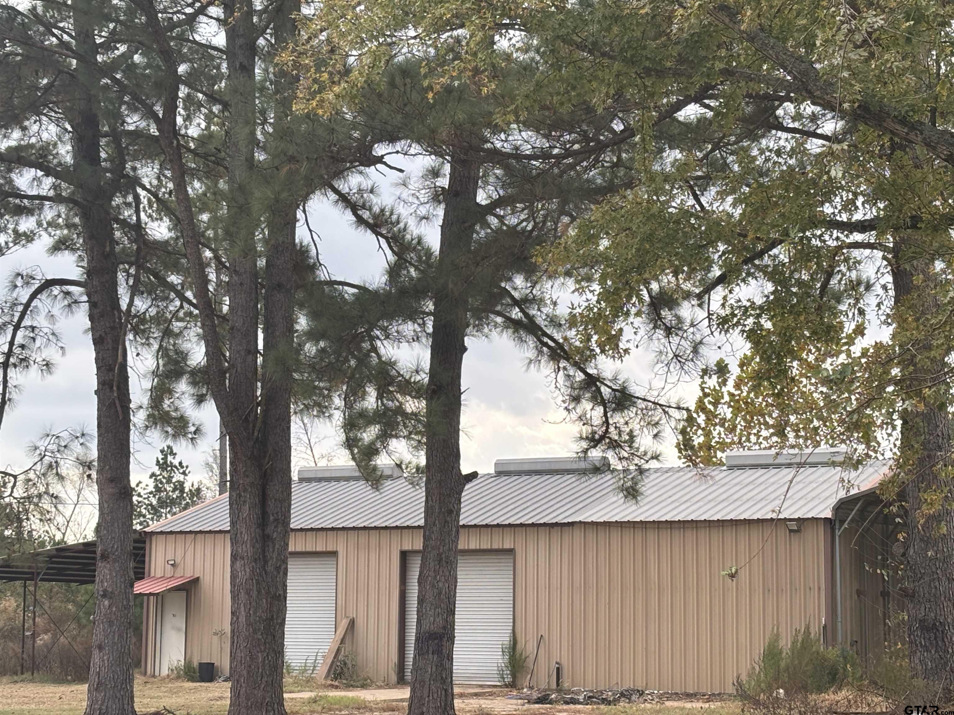 8123 Cherokee Trace Gilmer, TX 75644 - Photo 24 of 26 a view of a house with a tree in the background