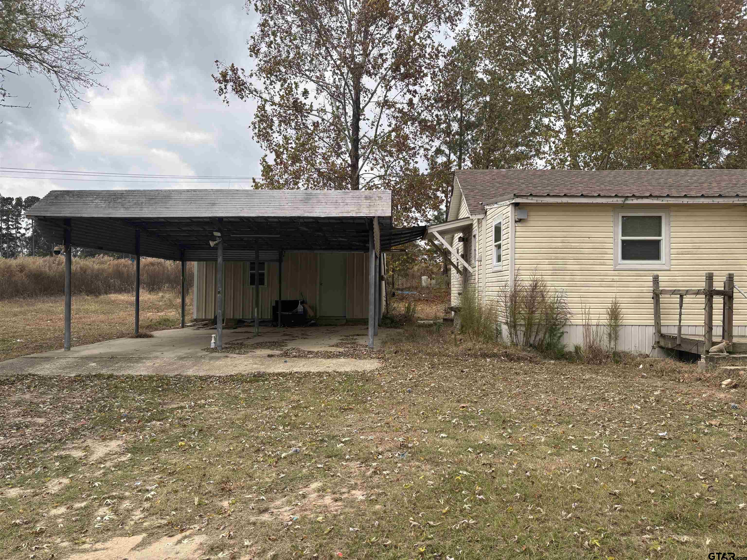 8123 Cherokee Trace Gilmer, TX 75644 - Photo 3 of 26 a house with trees in the background