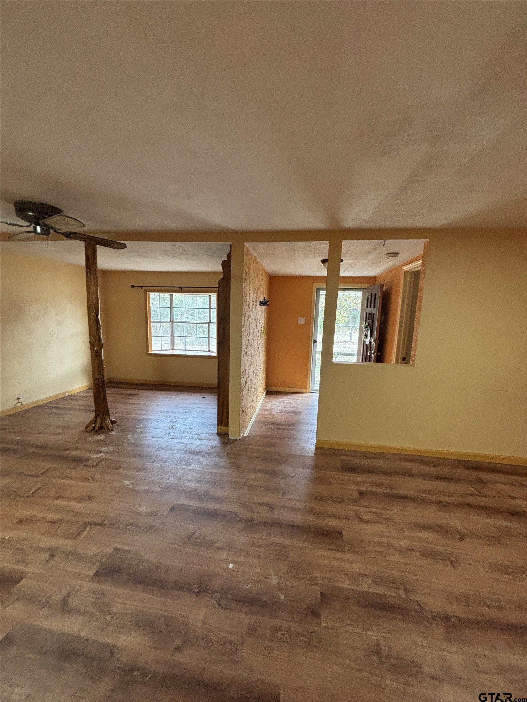 8123 Cherokee Trace Gilmer, TX 75644 - Photo 4 of 26 a view of empty room with wooden floor and fan