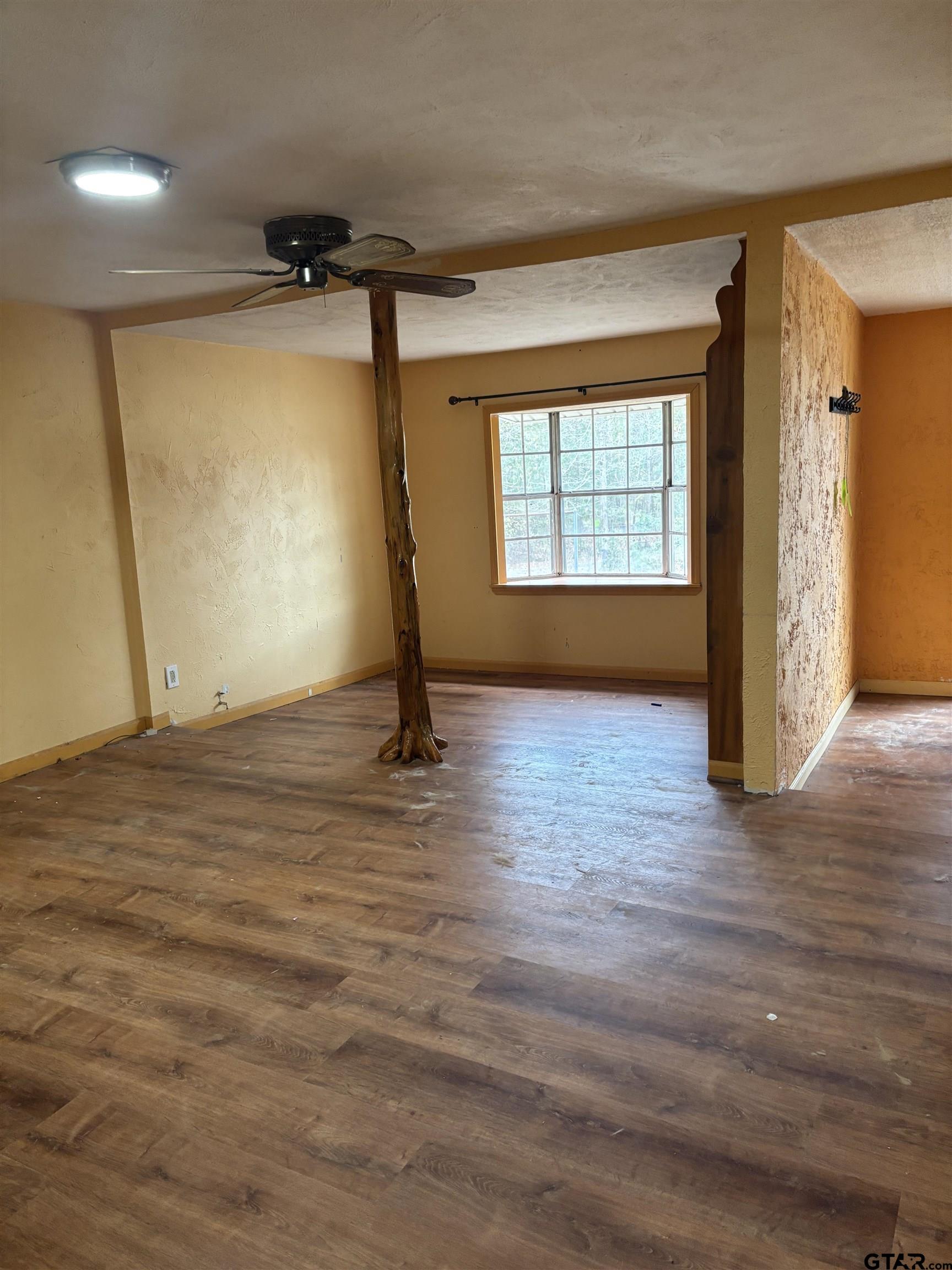 8123 Cherokee Trace Gilmer, TX 75644 - Photo 6 of 26 a view of empty room with wooden floor and fan