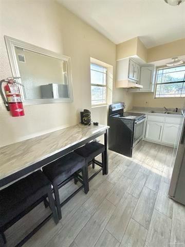 1109 Jackson Street Zapata, TX 78076 - Photo 11 of 30 a kitchen with a sink cabinets and wooden floor