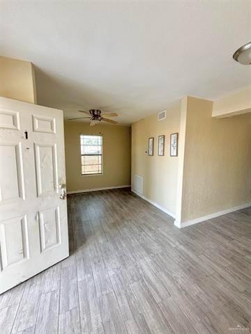 1109 Jackson Street Zapata, TX 78076 - Photo 16 of 30 a view of an empty room with a window and wooden floor