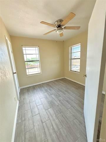 1109 Jackson Street Zapata, TX 78076 - Photo 23 of 30 a view of an empty room with a window and wooden floor