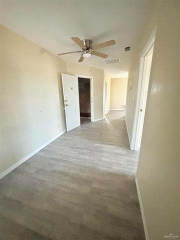 1109 Jackson Street Zapata, TX 78076 - Photo 24 of 30 a view of a hallway with a chandelier fan and windows