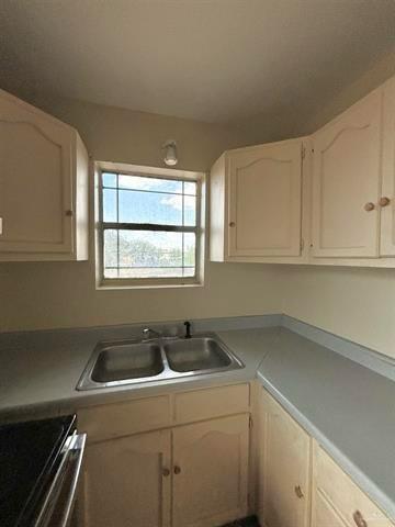 1109 Jackson Street Zapata, TX 78076 - Photo 27 of 30 a kitchen with a sink and cabinets