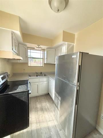 1109 Jackson Street Zapata, TX 78076 - Photo 5 of 30 a kitchen with granite countertop a refrigerator and a sink