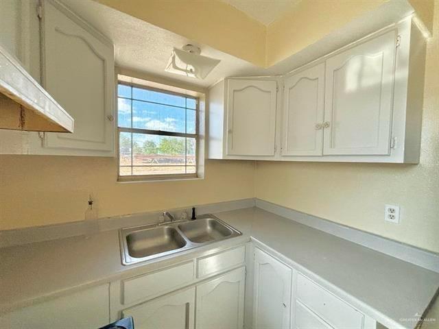 1109 Jackson Street Zapata, TX 78076 - Photo 6 of 30 a bathroom with a sink and cabinets