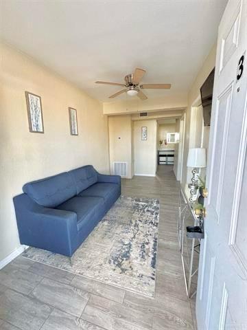 1109 Jackson Street Zapata, TX 78076 - Photo 7 of 30 a living room with a couch and a chandelier