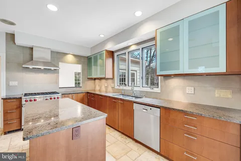 a kitchen with stainless steel appliances granite countertop a sink and a stove