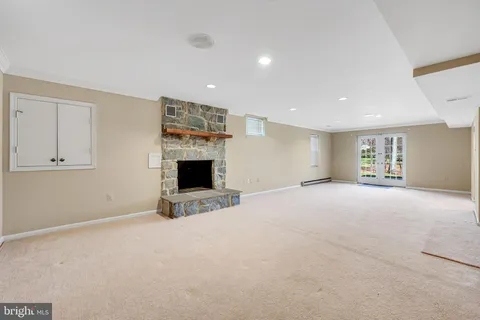 a view of an empty room with a fireplace