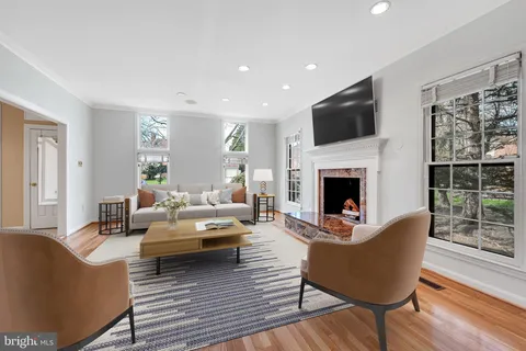 a living room with fireplace furniture and a flat screen tv