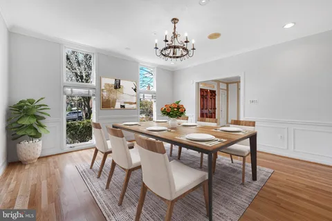 a view of a dining room with furniture wooden floor and chandelier