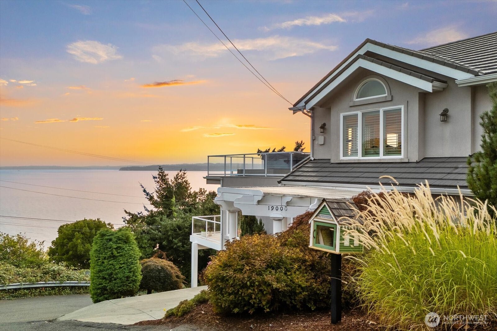 a front view of a house with a garden