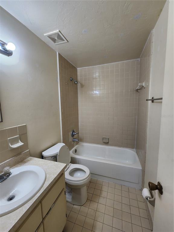 4021 Southwest 37 Street, Unit C Gainesville, FL 32608 - Photo 12 of 25 a bathroom with a sink a toilet and shower