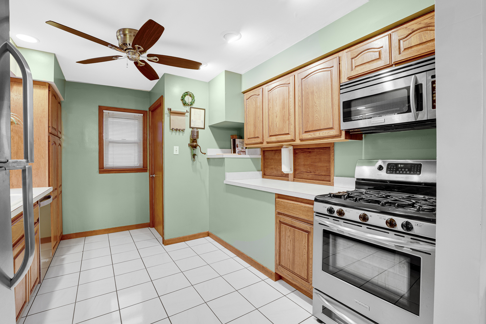 1247 Hickory Road Homewood, IL 60430 - Photo 9 of 22 a kitchen with cabinets a stove and a refrigerator