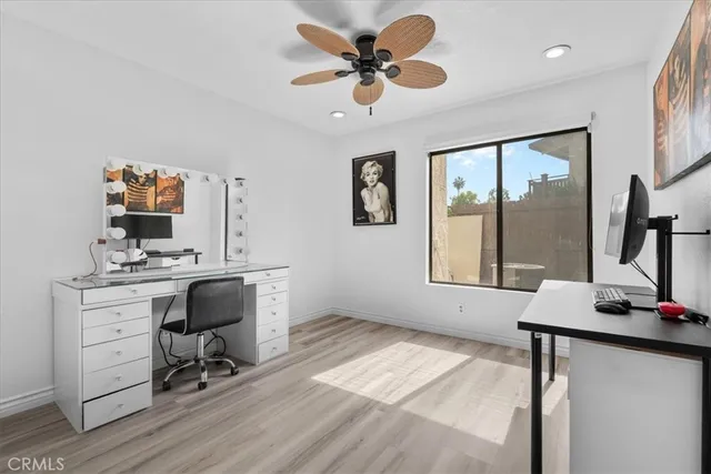 a view of a workspace with furniture and wooden floor