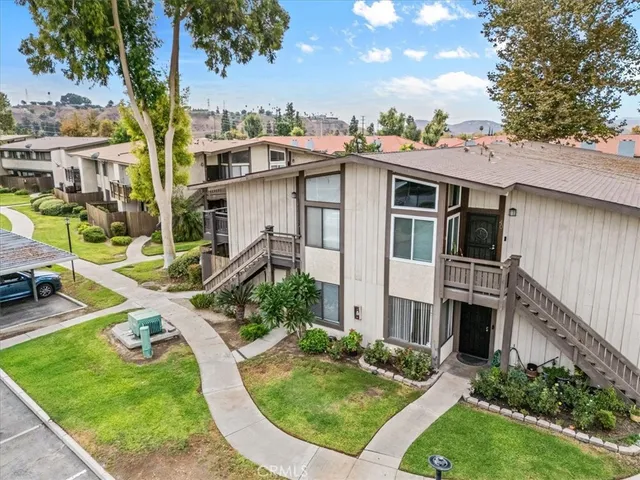an aerial view of residential houses with city view